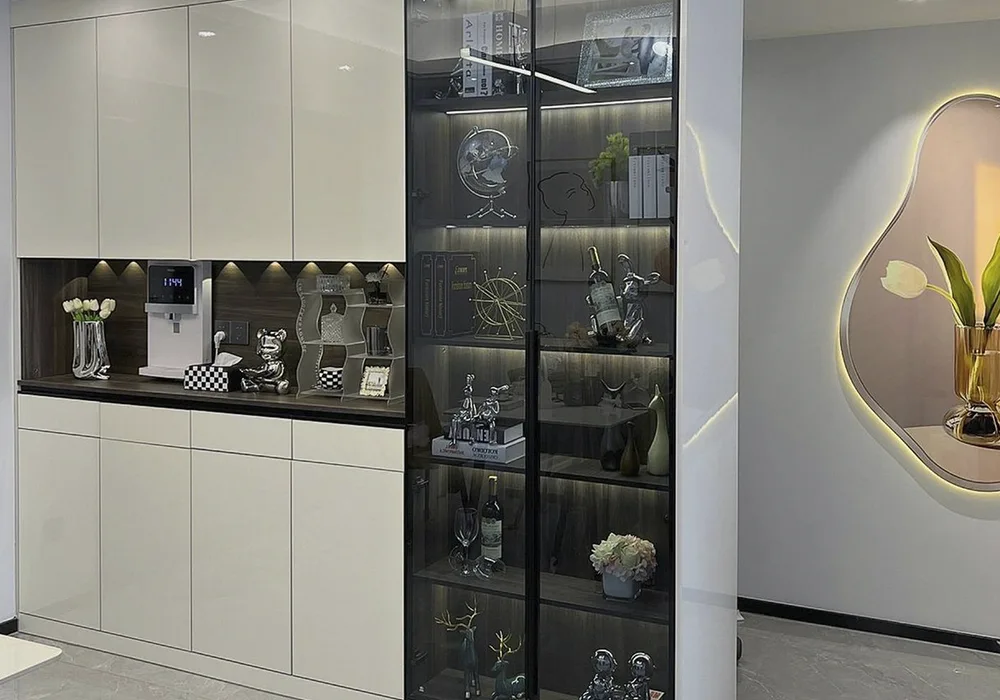 Modern interior with white custom cabinet, glass shelves, LED lighting and decorative accents.